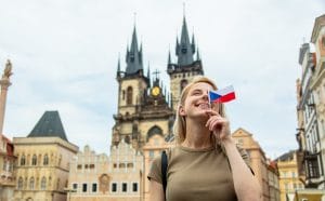 Blonde woman with a flag at central square in Prague, Czech Republic