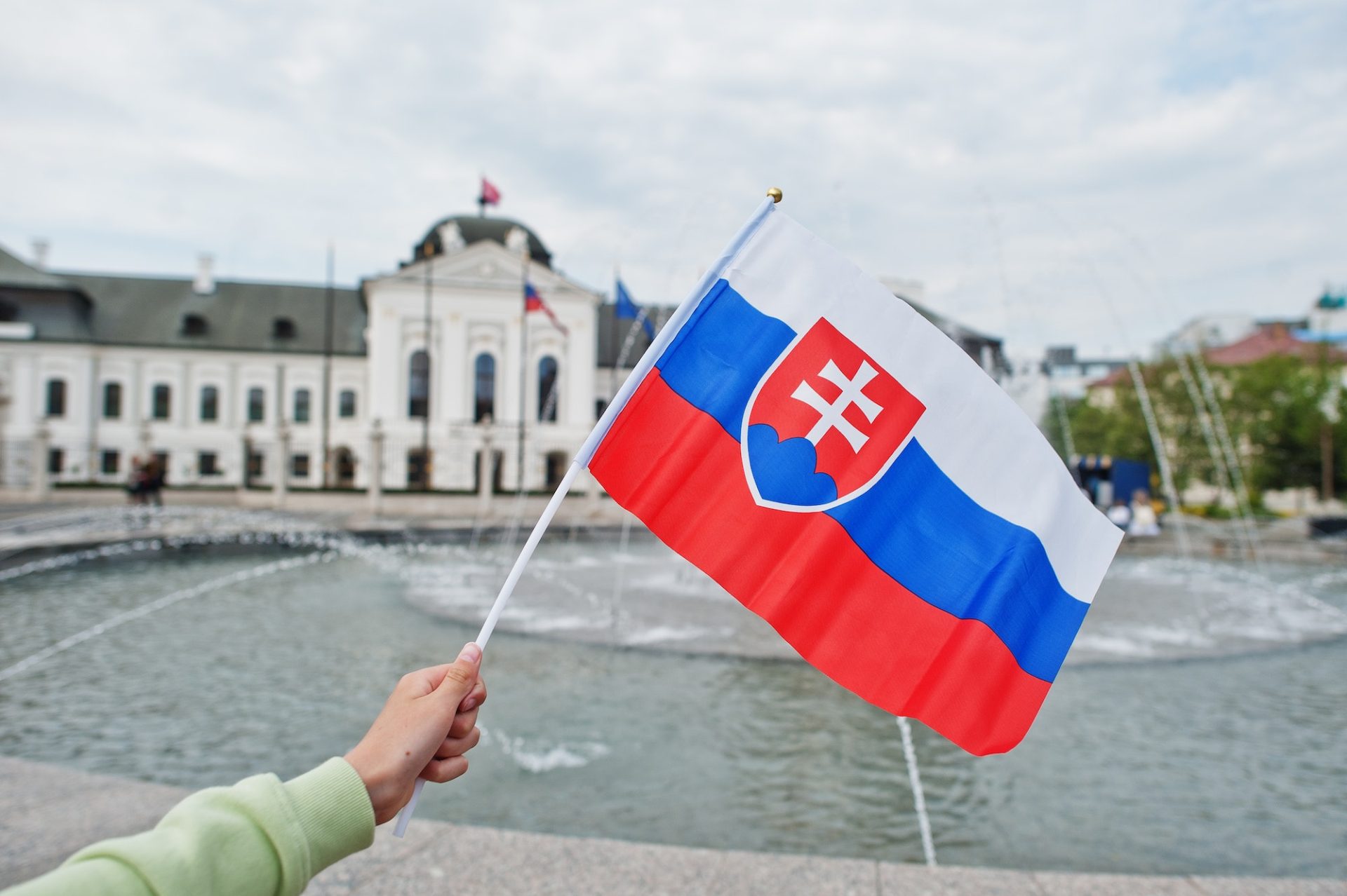 Flag of Slovakia against Grassalkovich Palace. Residence of the president of Slovakia in Bratislava.
