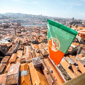 Portuguese flag on the Porto city background