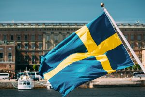 Stockholm, Sweden. Waving Swedish Flag In Stockholm Street. Stockholm, Sweden. Waving Swedish Flag
