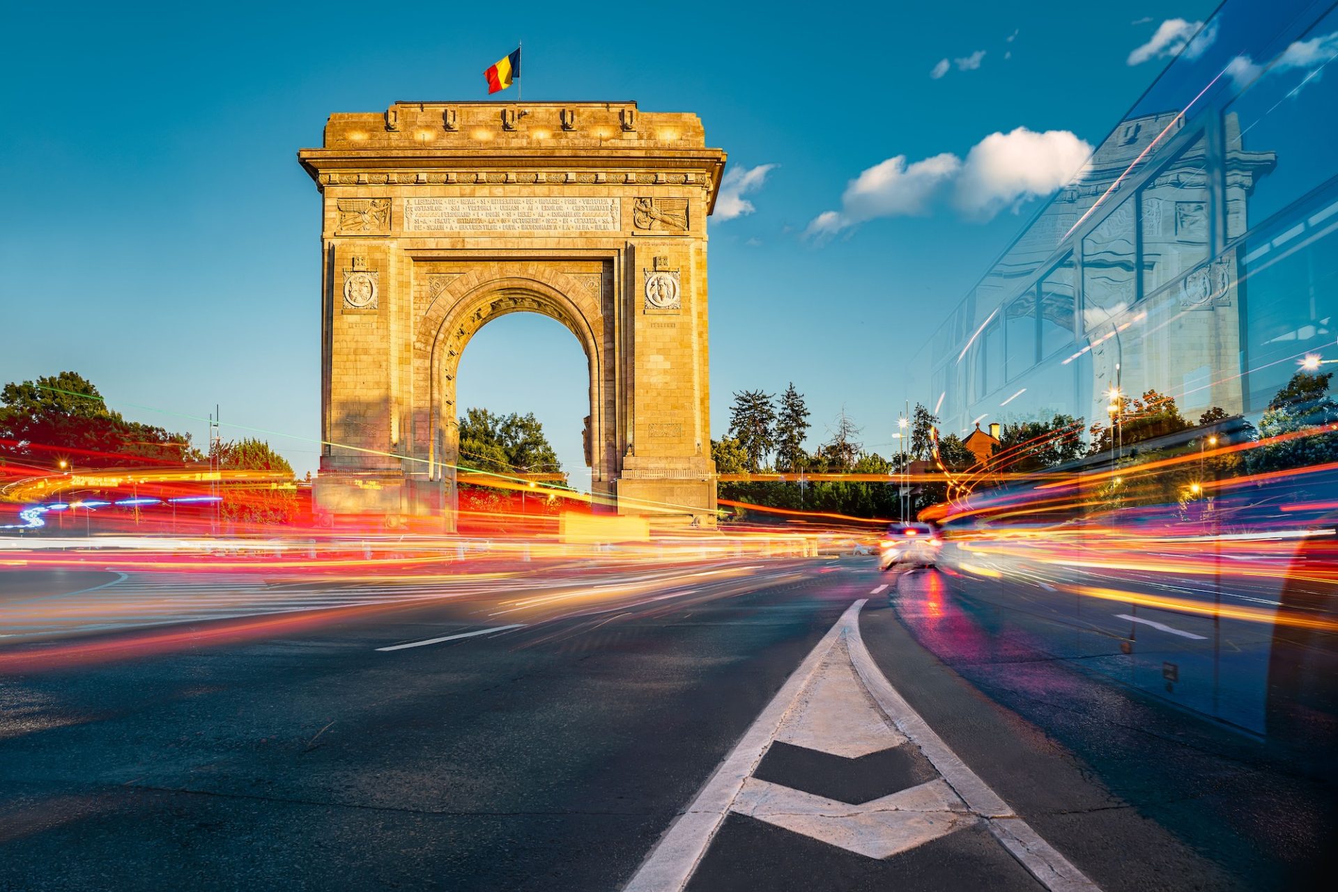 Triumphal arch, historical landmark in Bucharest, Romania with long exposure, car light trails