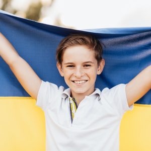 Ukrainian child boy with yellow and blue flag of Ukraine