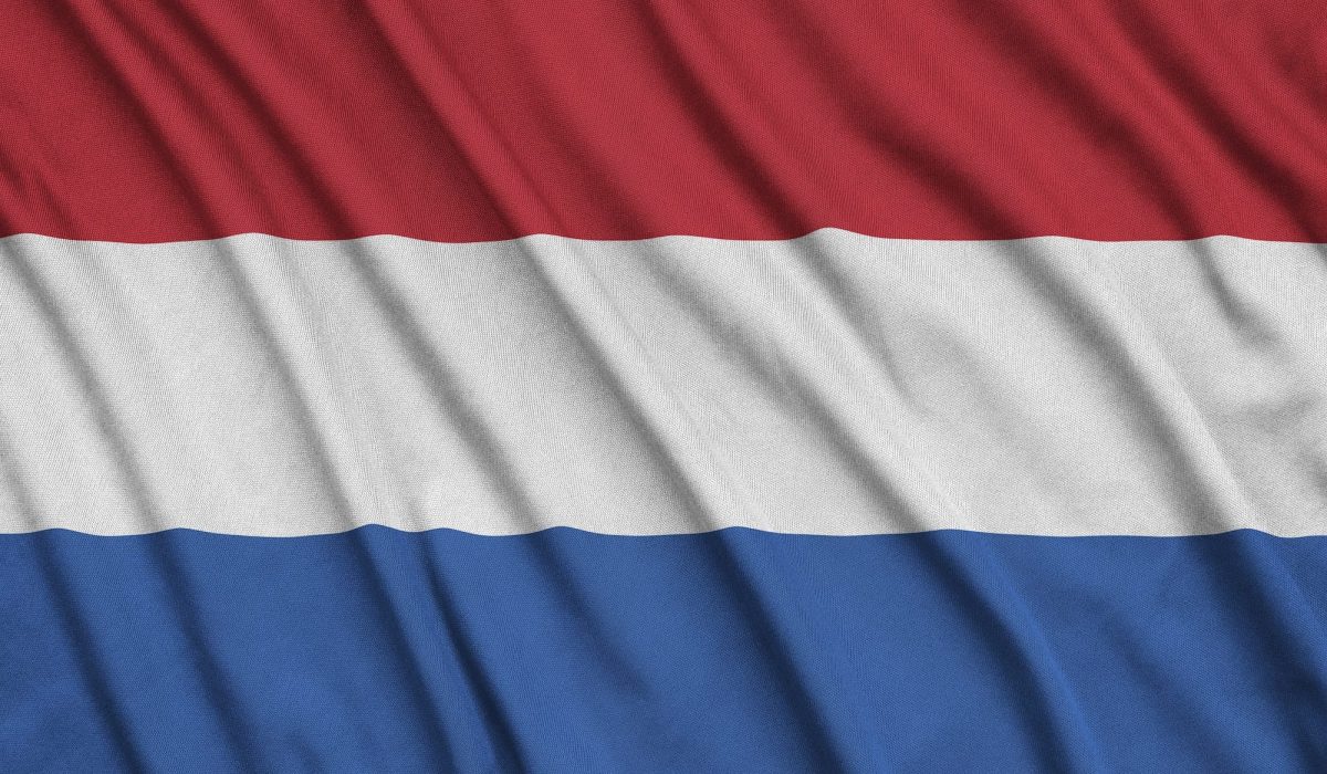 Netherlands flag is depicted on a sports cloth fabric with many folds. Sport team waving banner